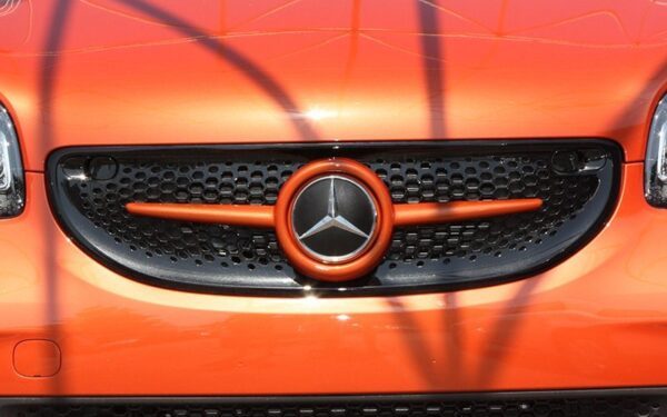 This is the Front Grille for Smart Fortwo 45. Its color is Lava Orange Metallic and it has Mercedes Emblem.
