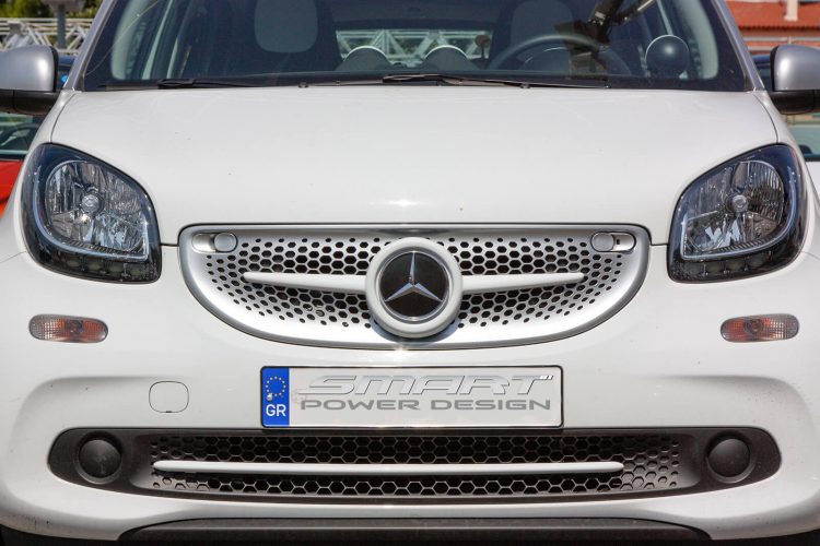 This is a close up photo of a white Front Grille installed on a Smart Fortwo 453.